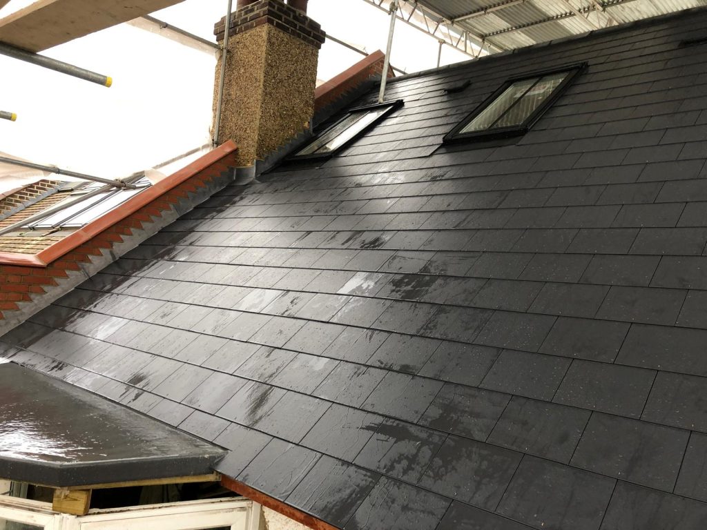 Slate roof installation with dormer and skylight windows on residential property in London
