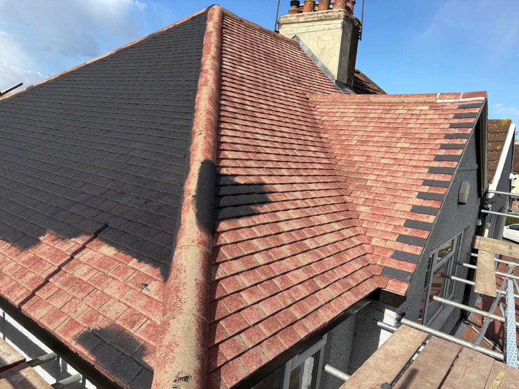 Half completed roof coating project showing before and after transformation in North London