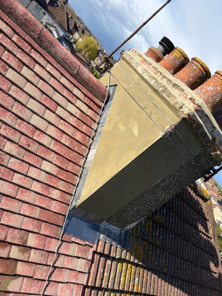 Chimney rendering and lead flashing repairs completed during roof restoration in North London